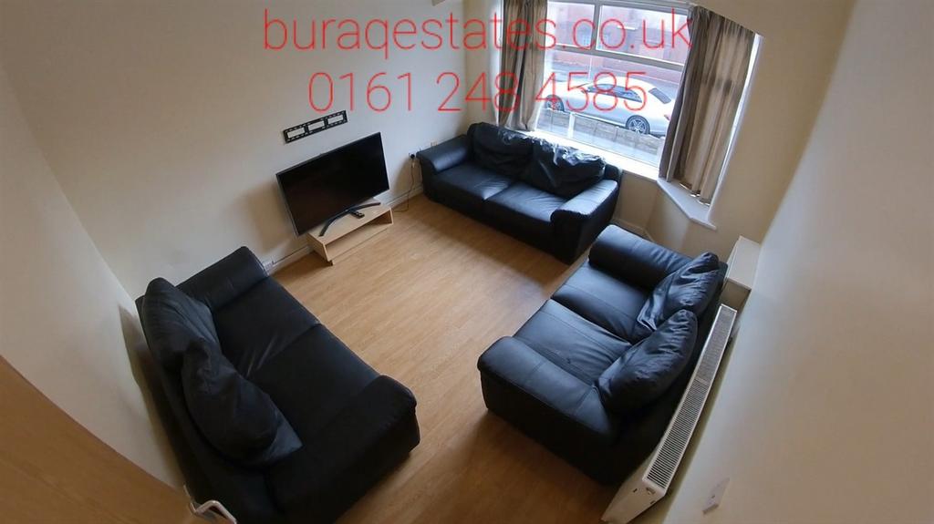 Bright, well-maintained living room with two co...