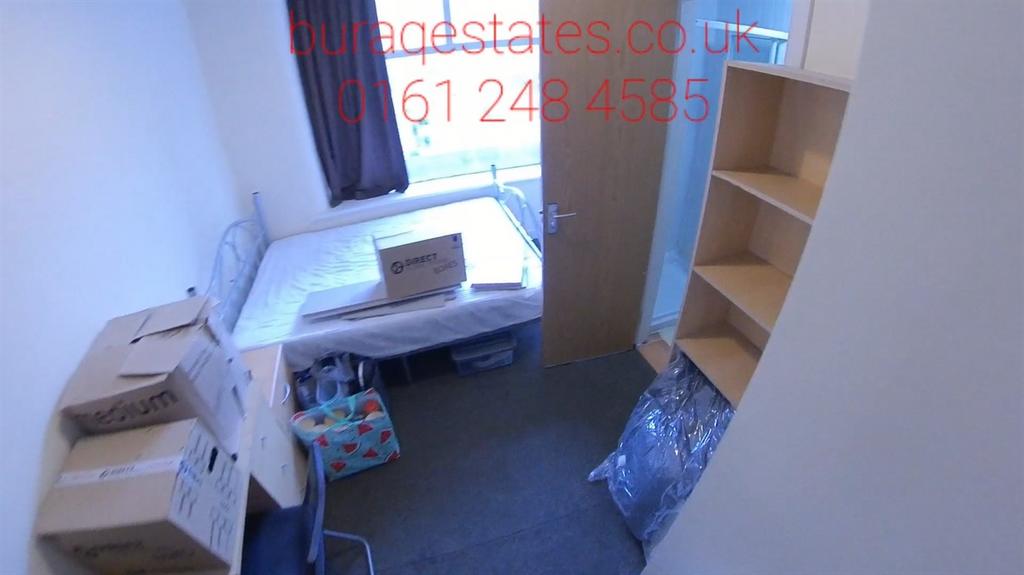 Compact bedroom with a built-in shelving unit, ...
