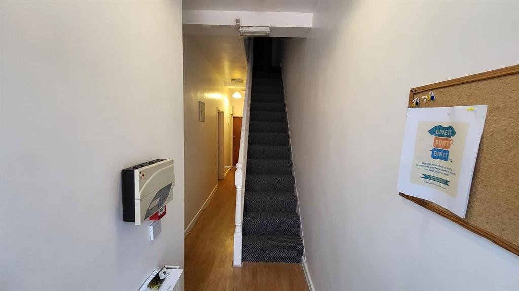 Bright, clean hallway with a straight staircase...