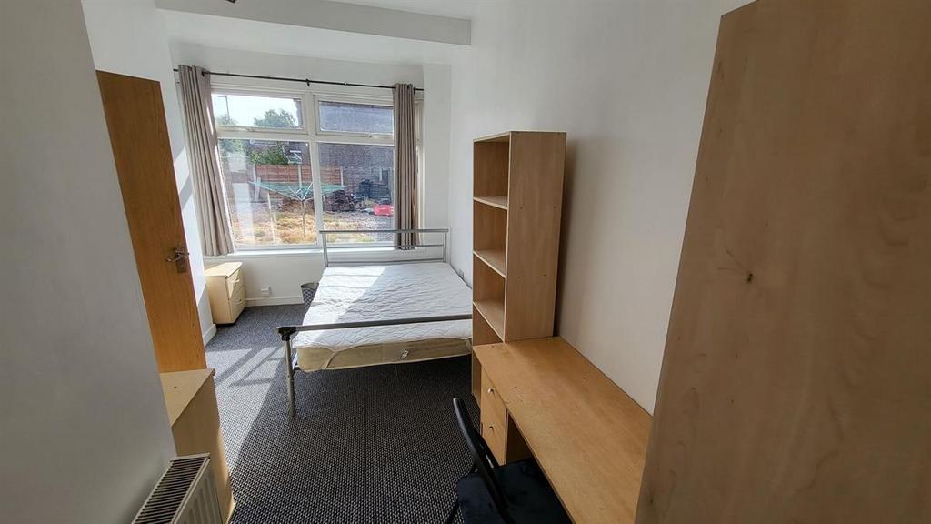 Bright furnished bedroom with a large window pr...