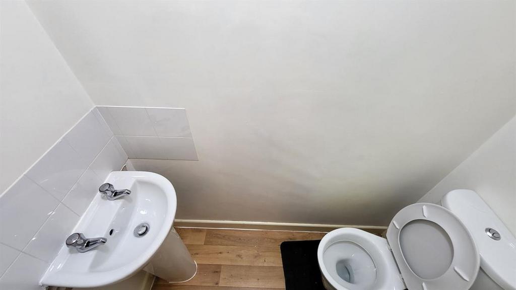 Compact and tidy bathroom with a clean white ba...