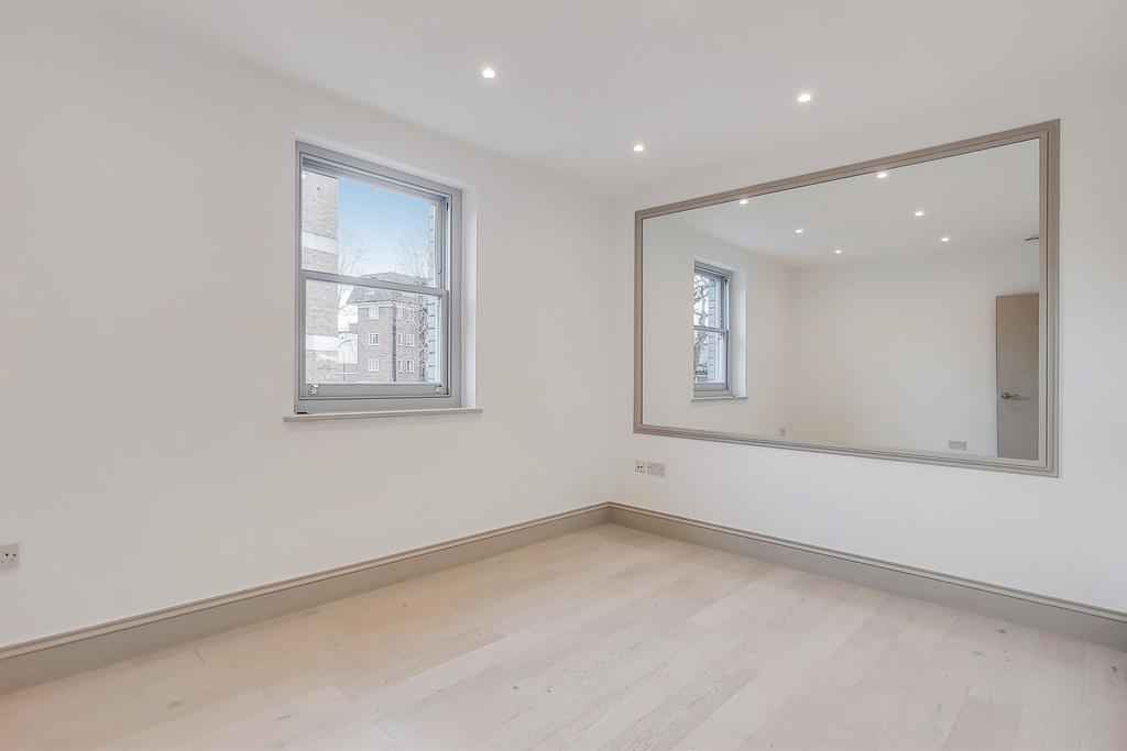 Bright, newly finished bedroom with light wood ...