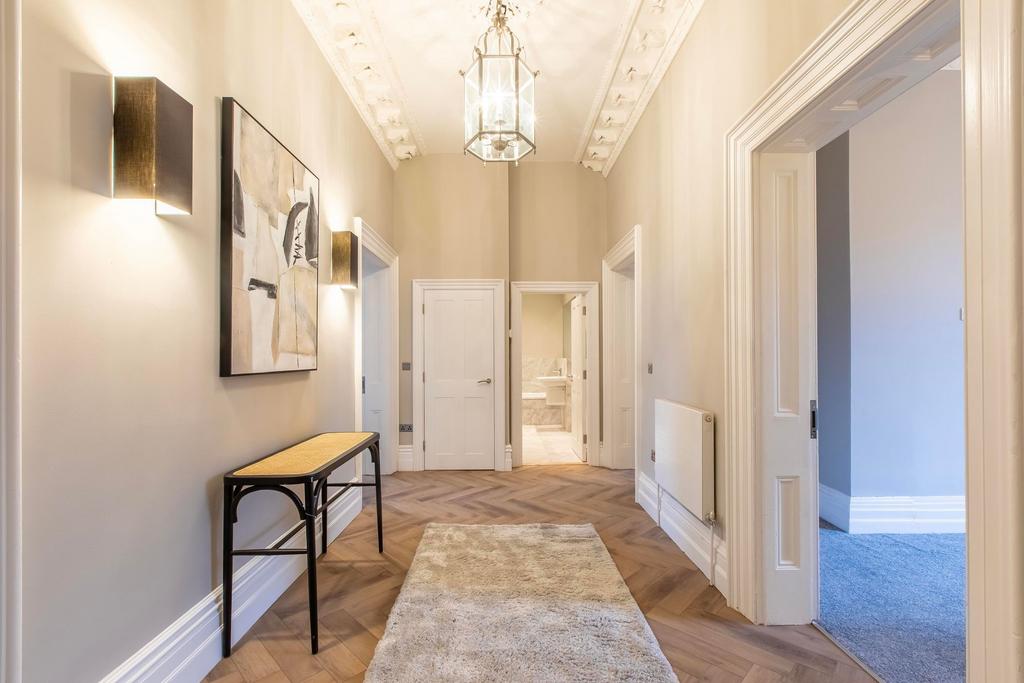 Bright, elegant hallway with decorative ceiling...