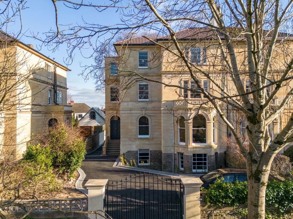 Elegant stone-fronted period building with gate...