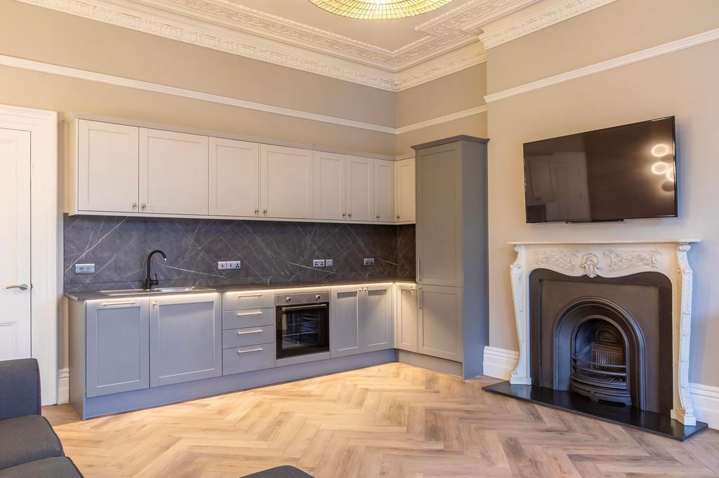 Stylish open-plan kitchen with modern grey shak...