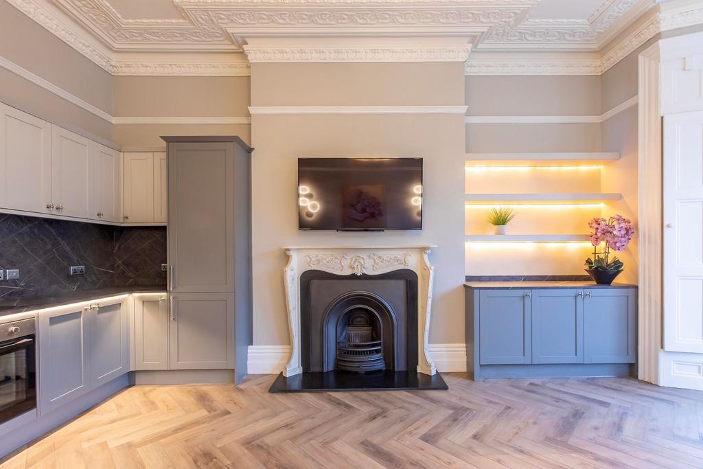 Elegant open-plan living area with ornate firep...