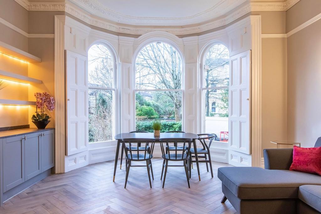 Bright, stylish living/dining area with a bay o...