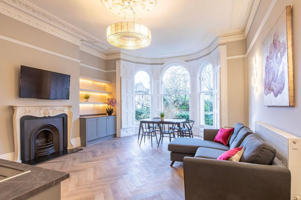Bright, stylish living area with large arched b...