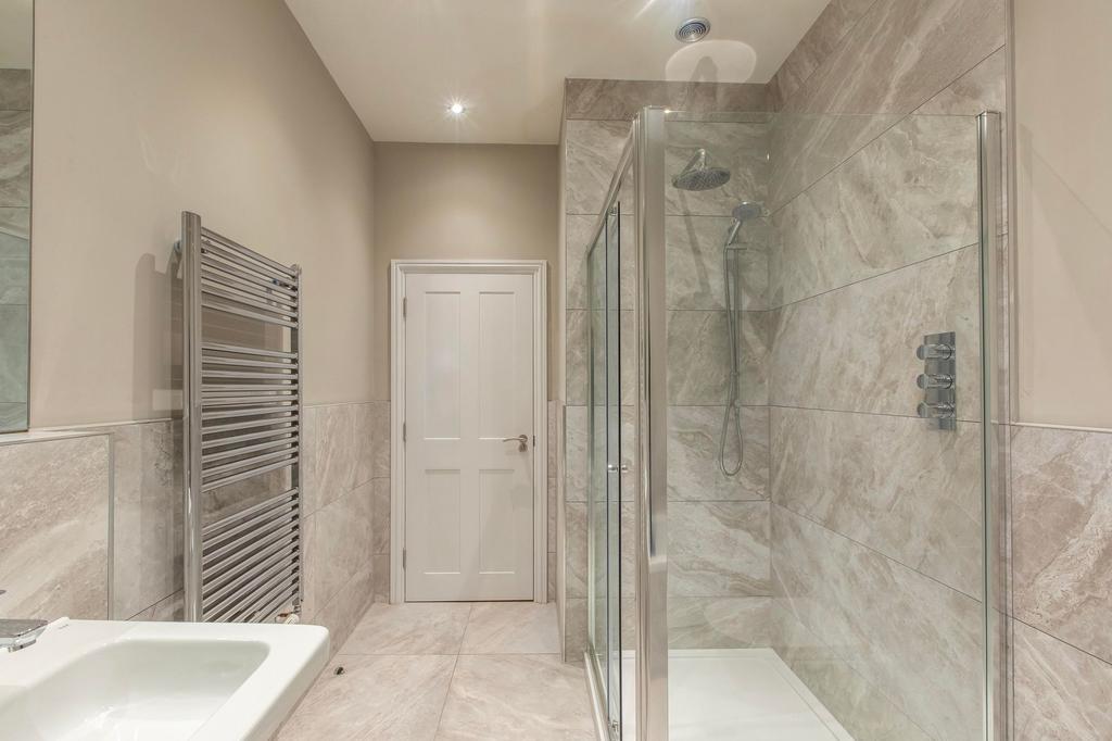 Bright, modern bathroom with large walk-in show...