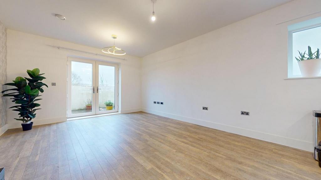 Bright, modern living room with light wood floo...