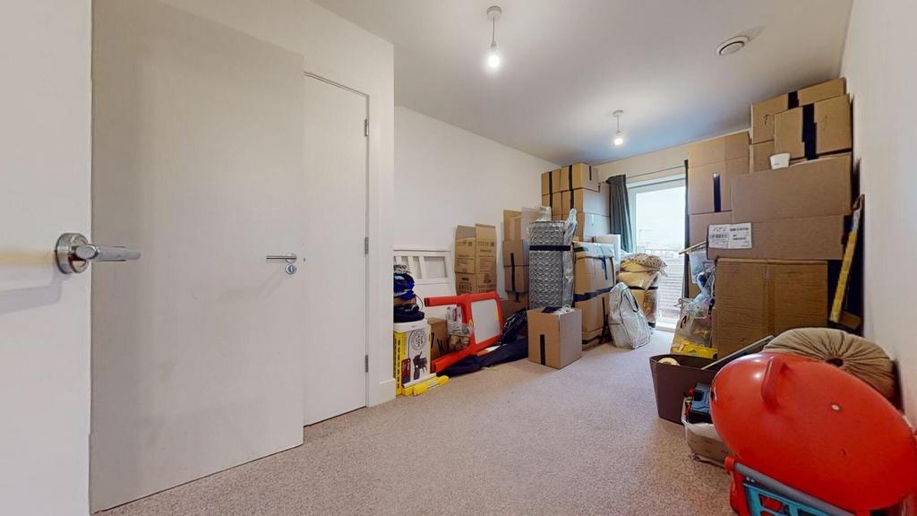 Well-lit upstairs storage room with carpeted fl...