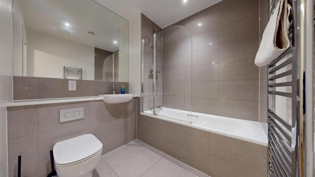 Modern tiled bathroom with a full-size bath and...