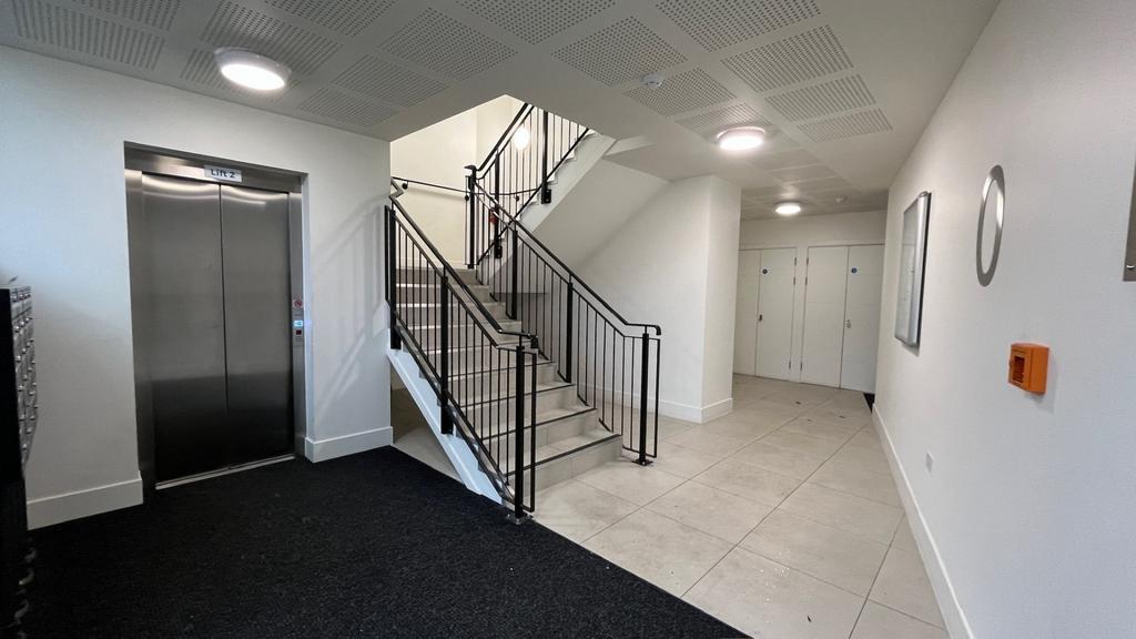 Bright, modern apartment entrance with elevator...