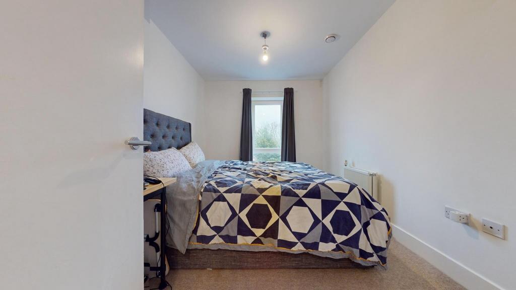 Bright, neatly presented bedroom with a comfort...