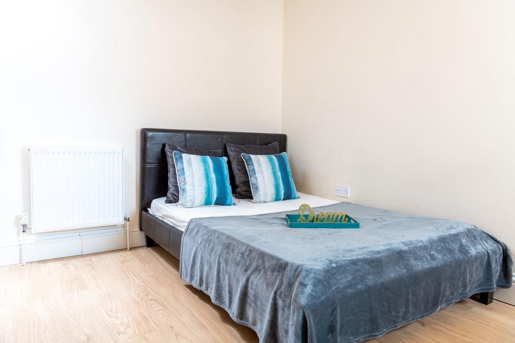 Bright, simply styled bedroom with a double bed...