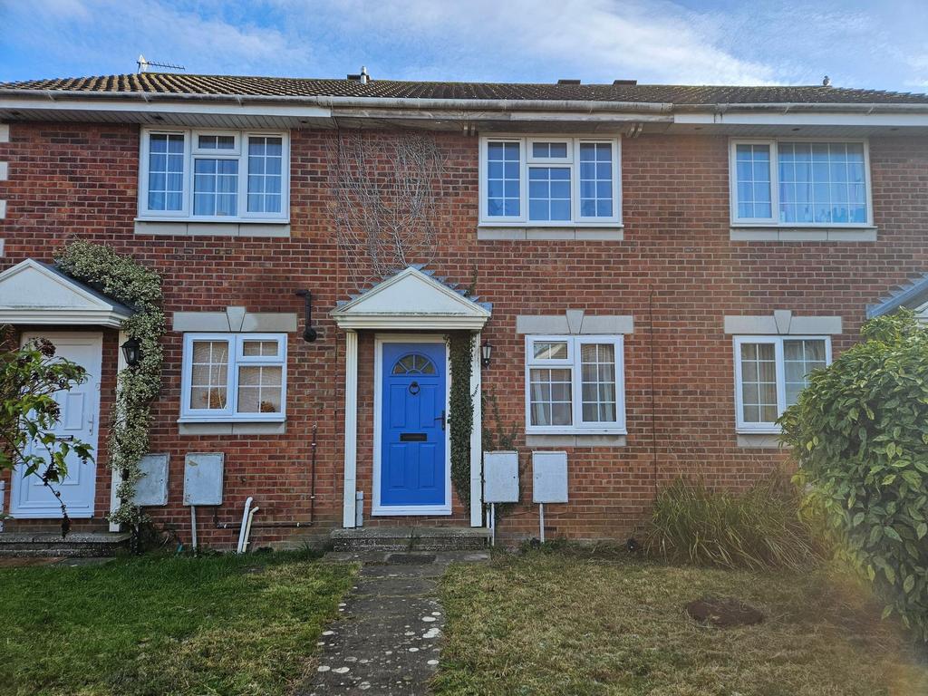 Red-brick terraced house with a bright blue fro...