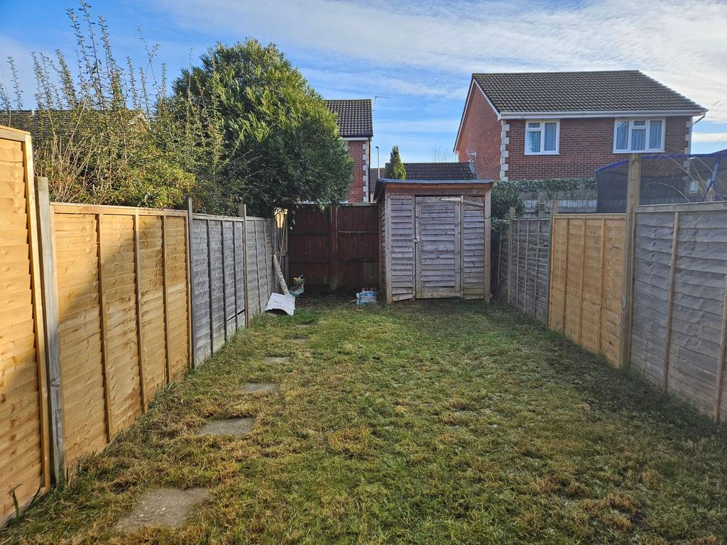 Private rear garden with a lawn, timber shed an...