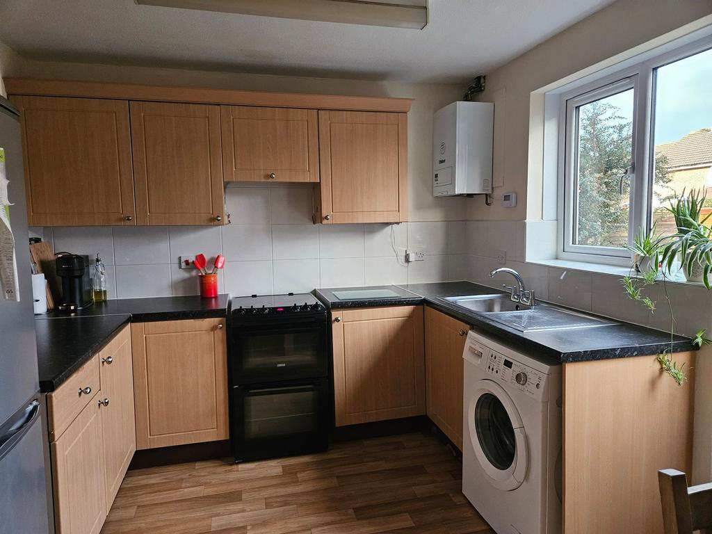 Bright, well-kept kitchen with light wood cabin...