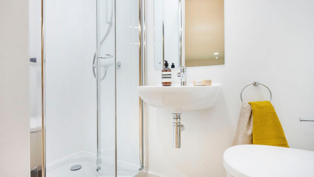 Bright, modern bathroom with a frameless glass ...
