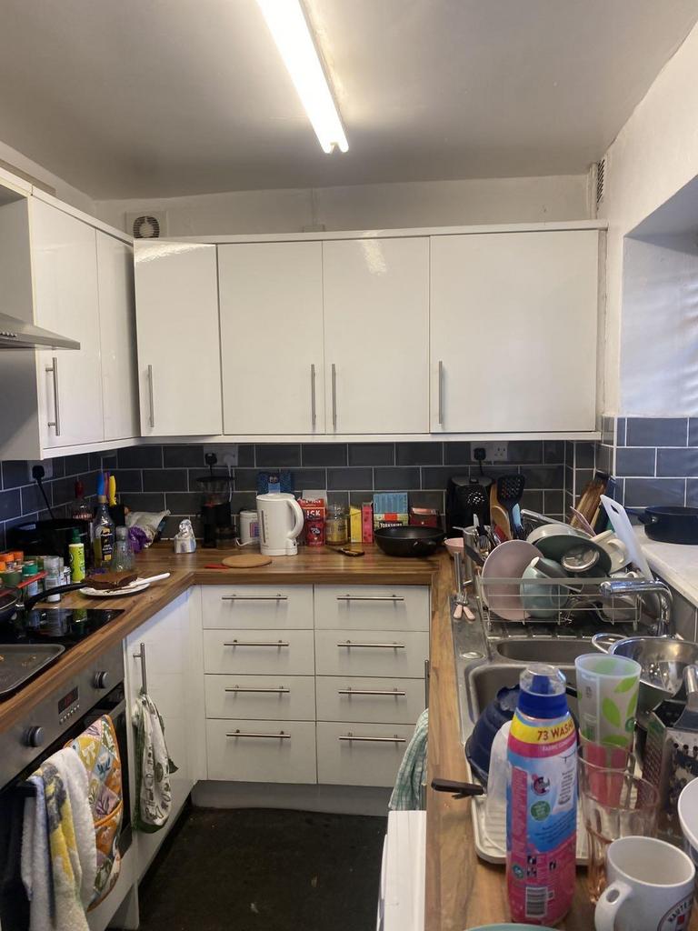 Bright fitted kitchen with modern white cabinet...