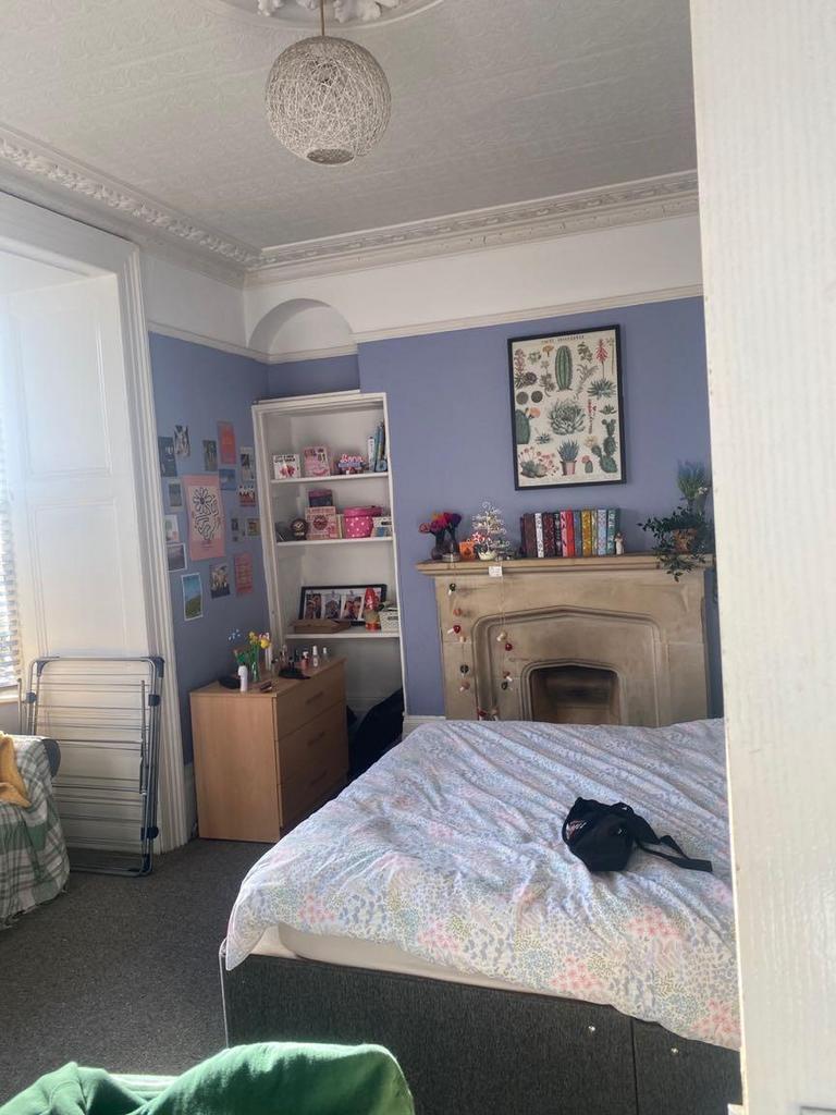 Bright, character bedroom with decorative corni...