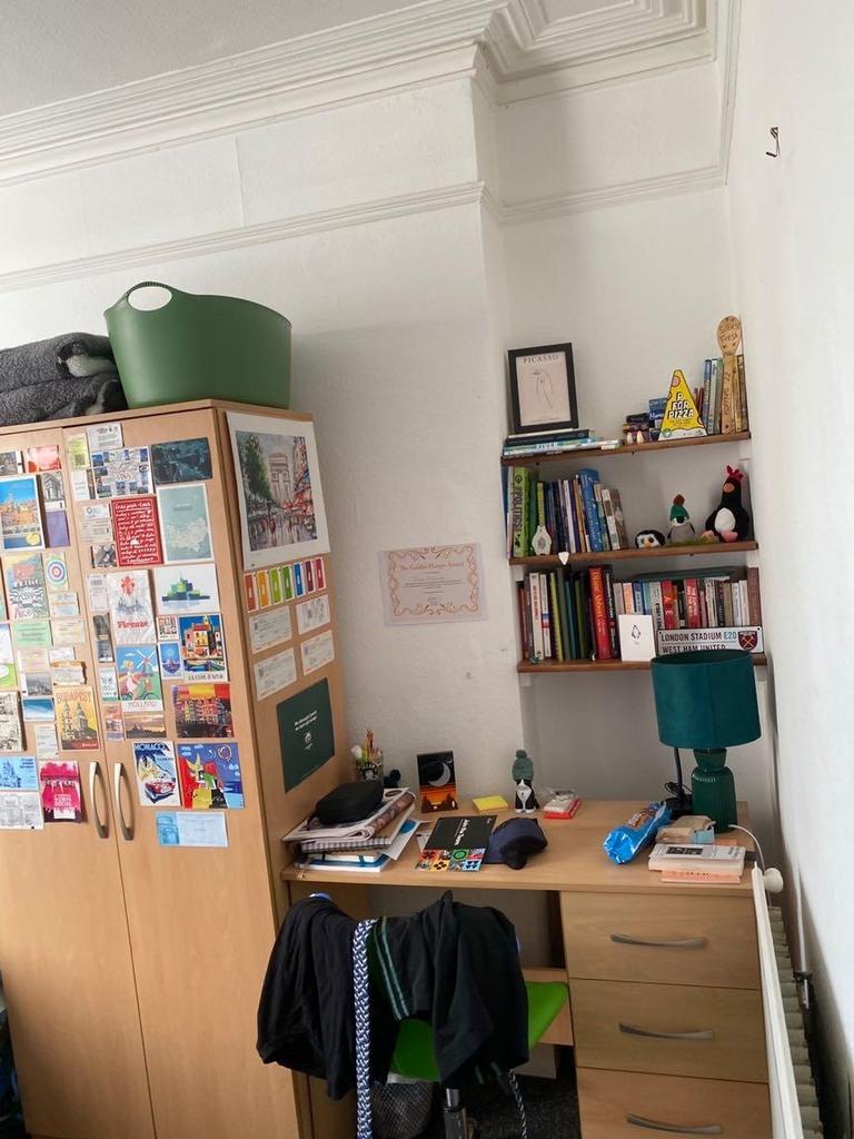Well-organised bedroom study corner with a wood...