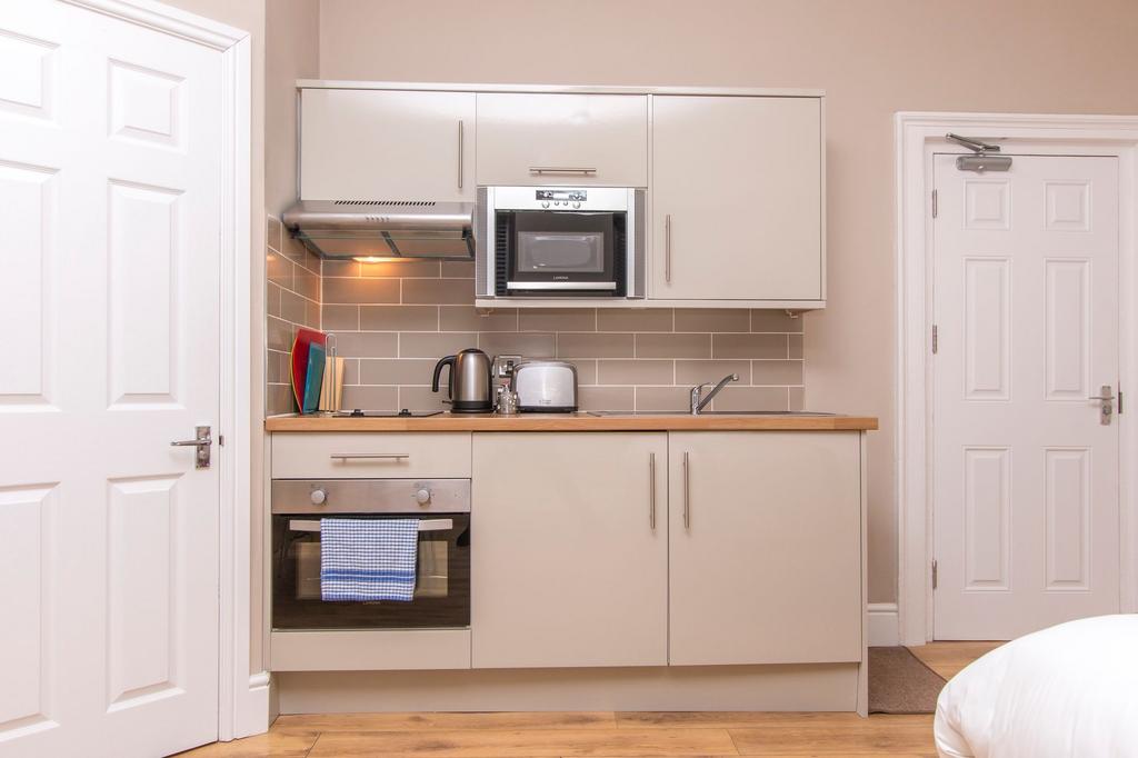 Well-appointed compact kitchen with neutral cab...