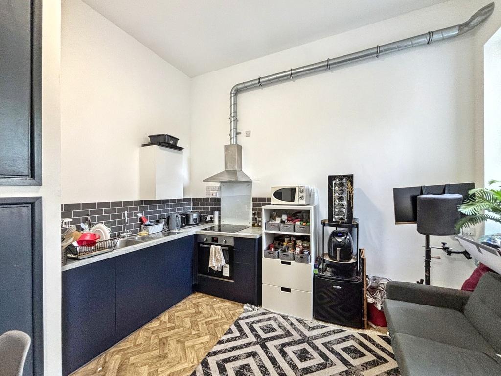 Contemporary kitchen corner with dark lower cab...