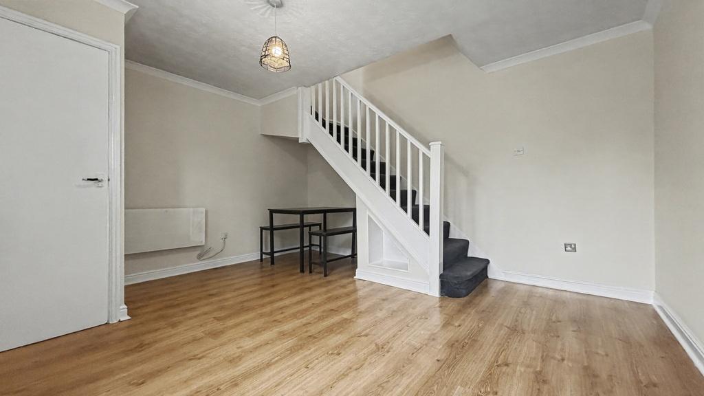 Bright, clean living room with wood-effect floo...