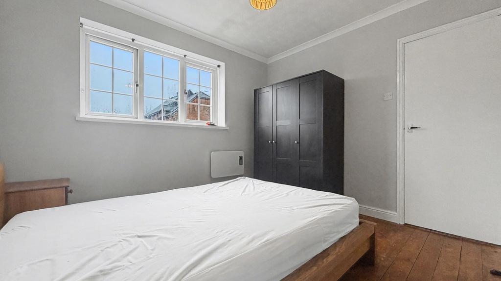 Bright, neatly presented bedroom with a large w...