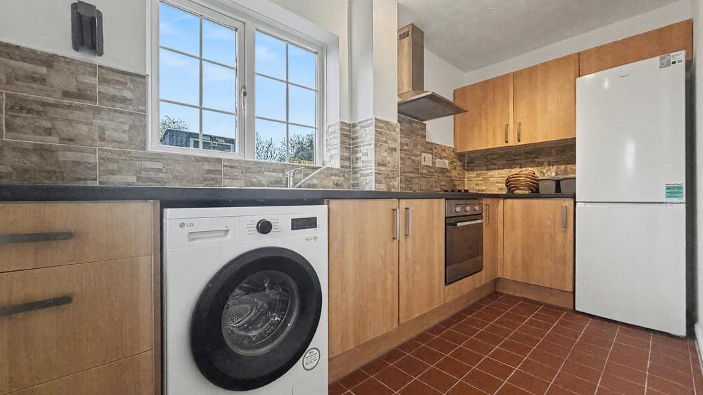 Bright modern kitchen with fitted wooden cabine...