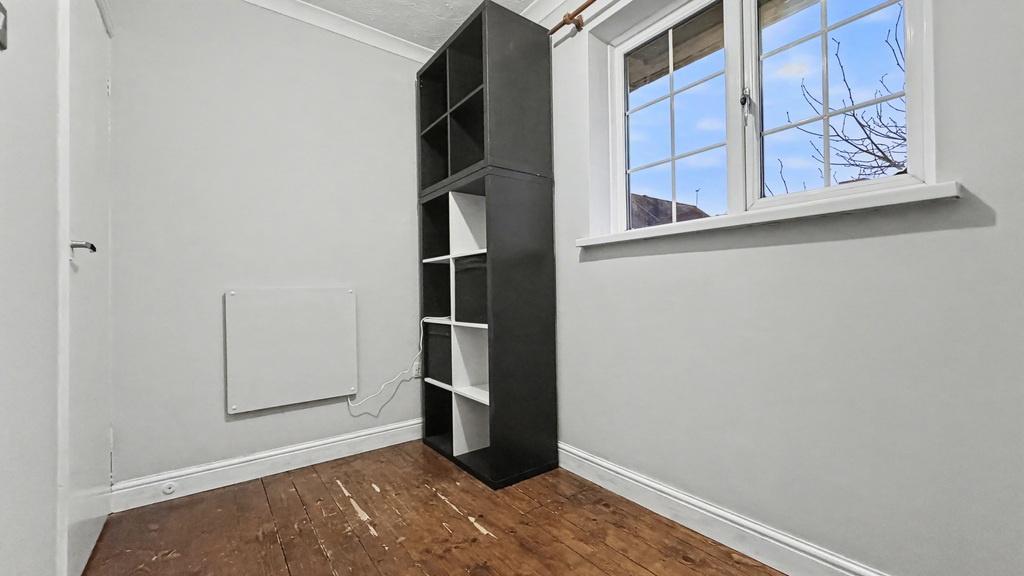 Compact bedroom with a large window bringing in...