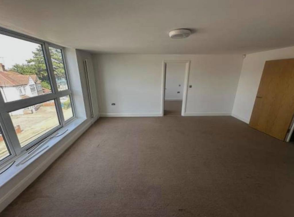 Bright, spacious living room with large windows...