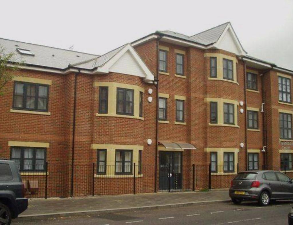 Well-maintained red-brick apartment building wi...