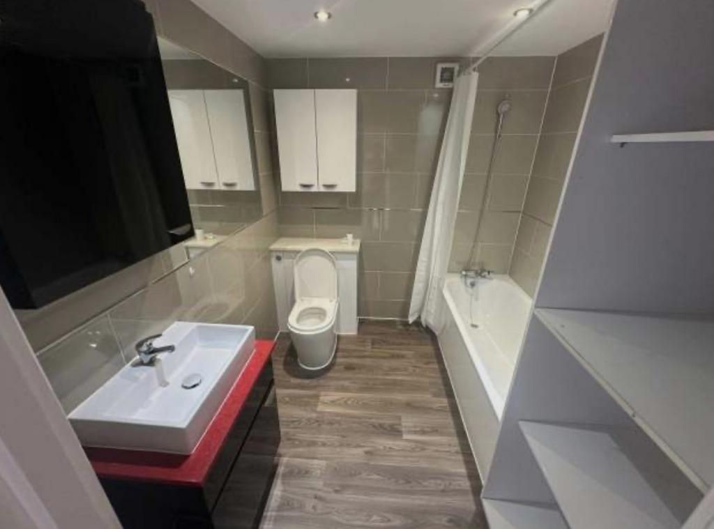 Bright modern bathroom with a combined bath and...