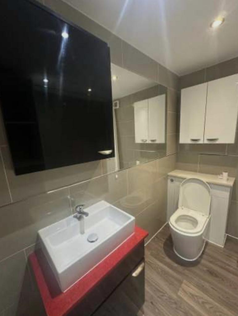 Modern bathroom with a sleek countertop basin, ...