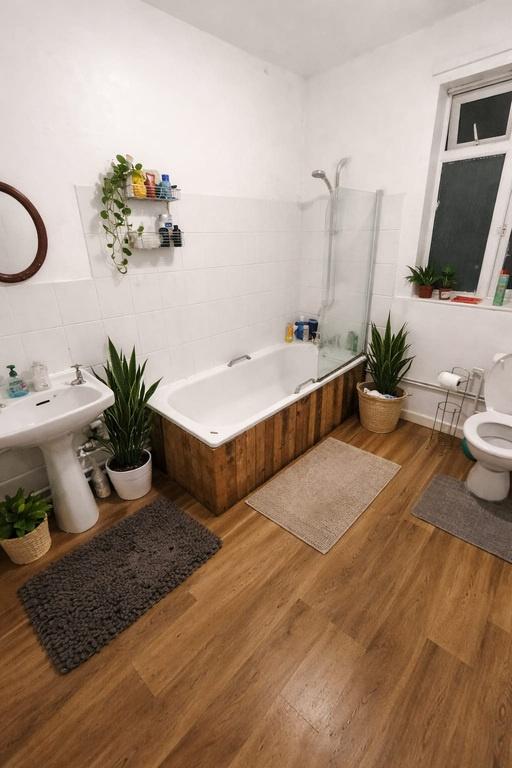 Bright, modern bathroom with a shower-over-bath...