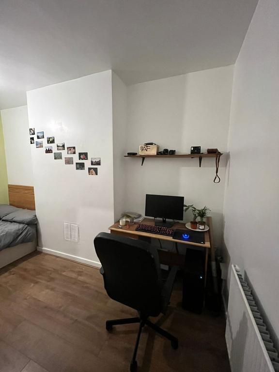 Neat furnished bedroom corner with a compact st...