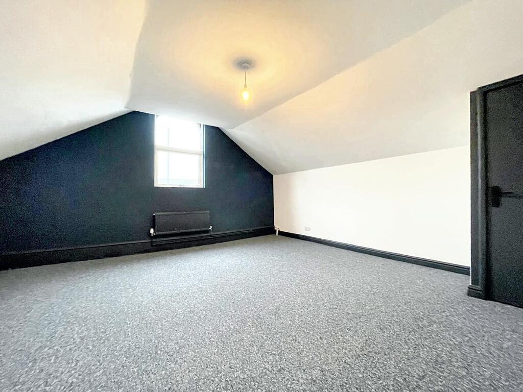 Bright, recently redecorated attic bedroom with...