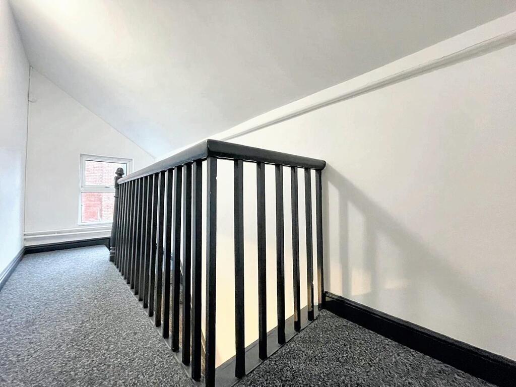 Bright painted upstairs landing with a black sp...