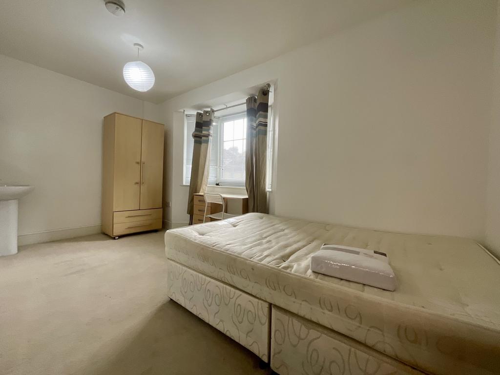 Bright, simply furnished single bedroom with a ...