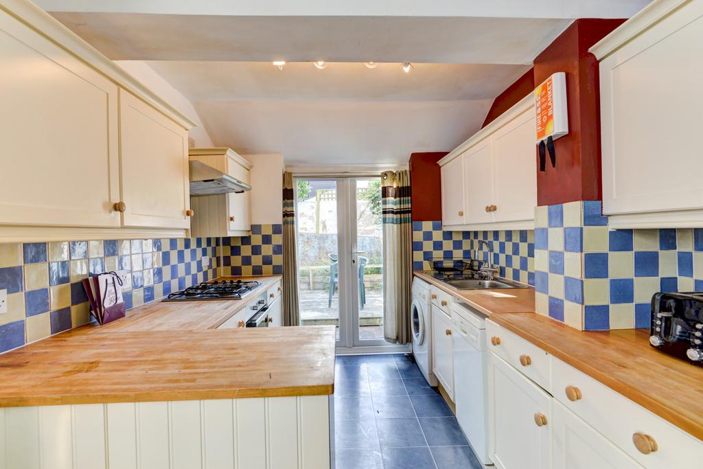 Bright galley kitchen with wooden worktops, cre...