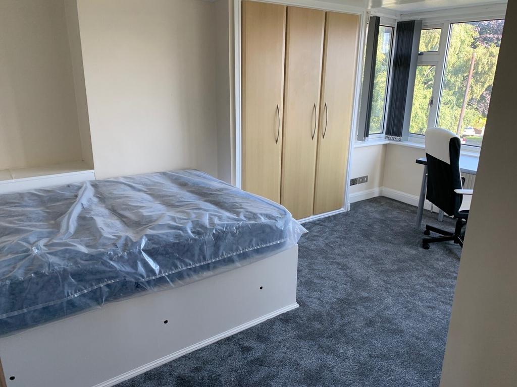Bright and well-maintained bedroom featuring a ...