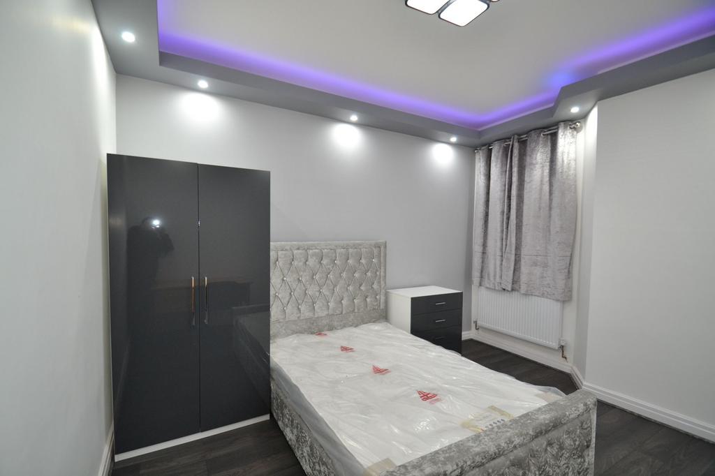 Stylish bedroom with a plush upholstered bed, g...