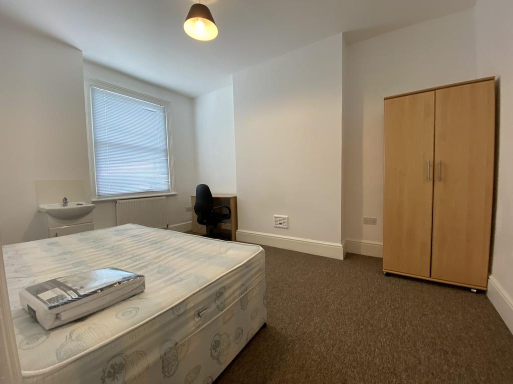 A well-maintained bedroom featuring a neatly ma...
