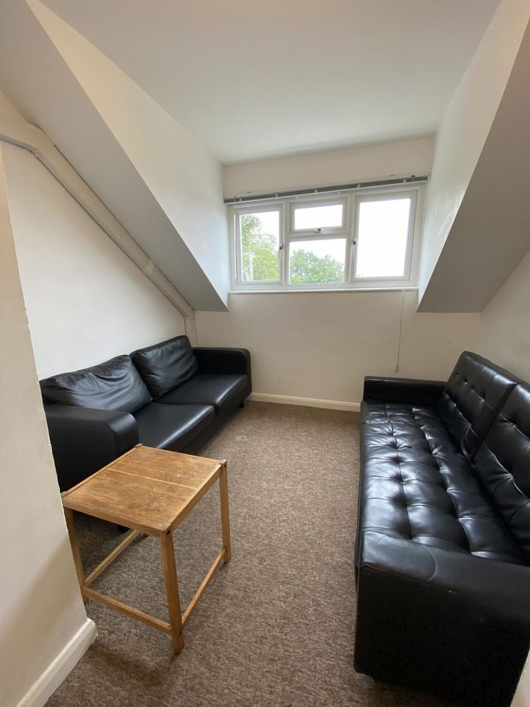 Cozy lounge with two black sofas facing each ot...