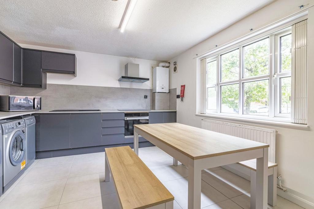 Bright and modern kitchen with ample natural li...