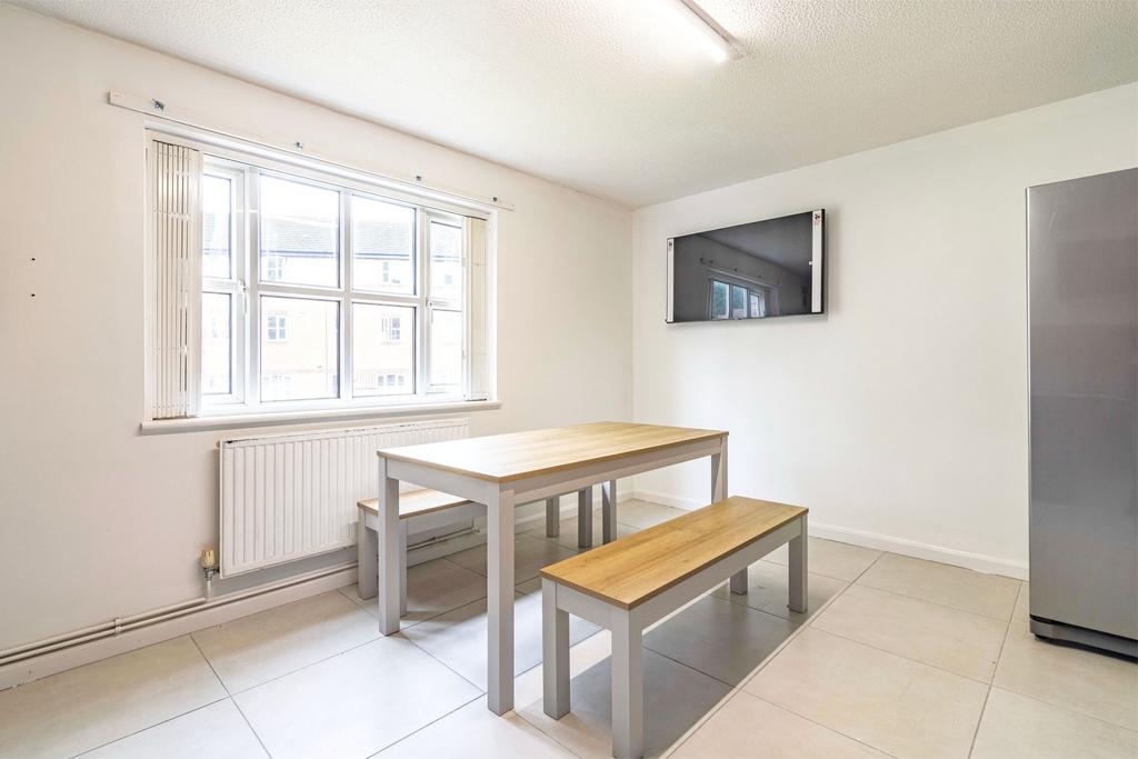 Bright and modern kitchen featuring a large win...