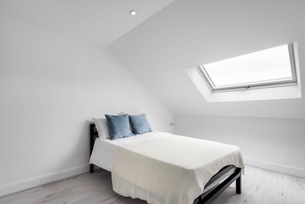 Bright and airy bedroom featuring a comfortable...