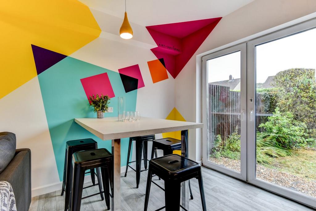 Bright, contemporary dining nook with a high ta...